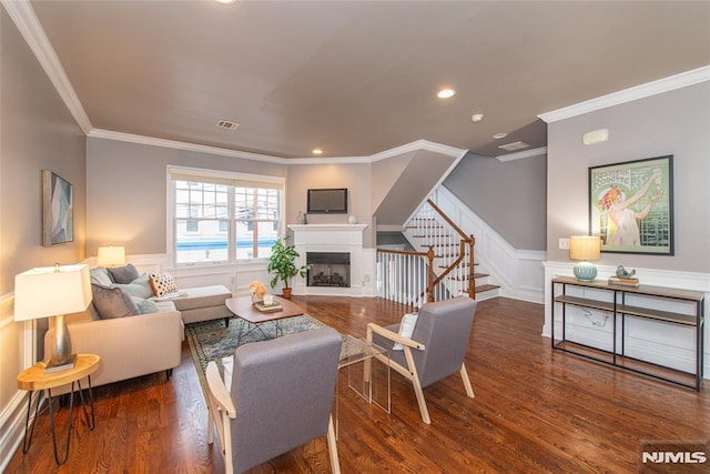 living room featuring ornamental molding and dark hardwood / wood-style floors