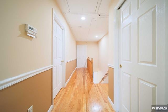 hallway with light hardwood / wood-style flooring