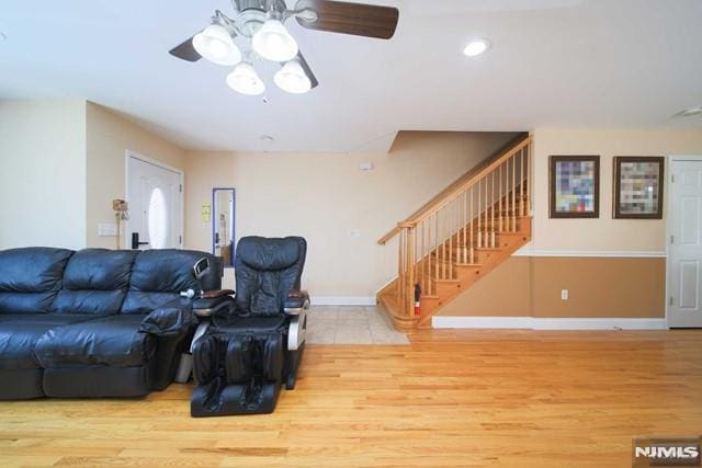 living room featuring ceiling fan and light hardwood / wood-style floors