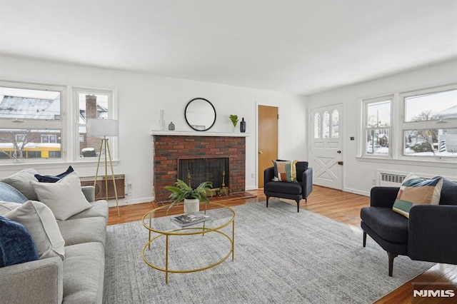 living room with plenty of natural light, hardwood / wood-style floors, and a fireplace