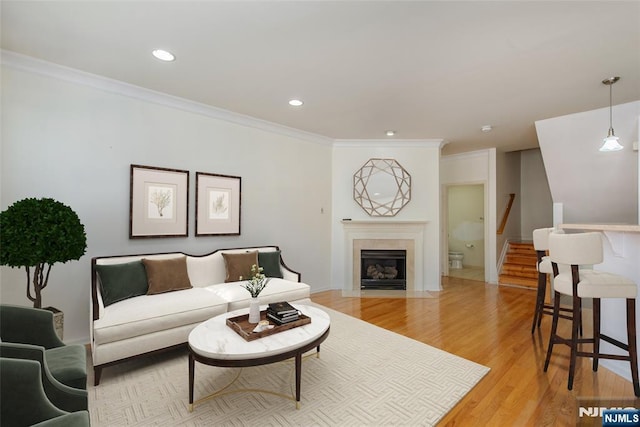 living room featuring crown molding and light wood-type flooring