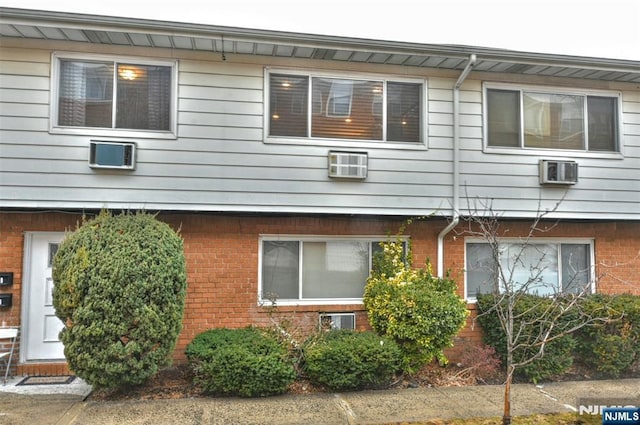 view of side of home with a wall mounted AC