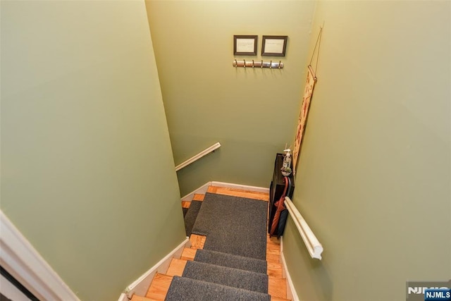 staircase with hardwood / wood-style flooring