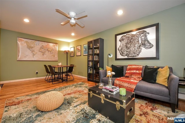 living room with wood-type flooring and ceiling fan