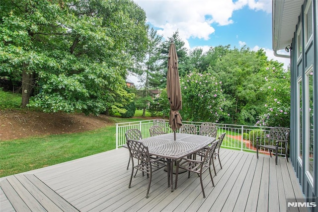 wooden terrace with a lawn