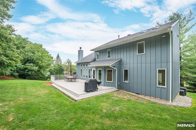 back of house featuring a lawn and central AC