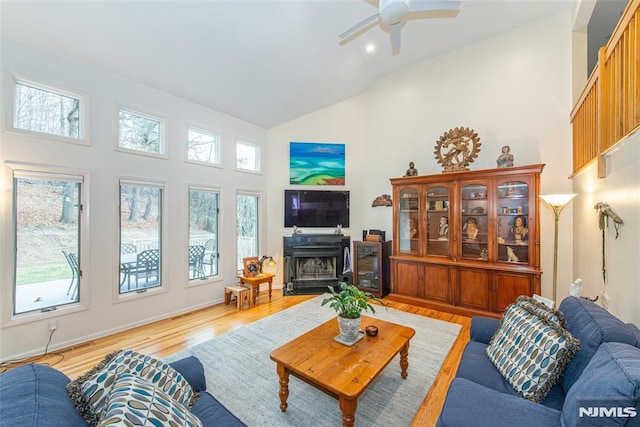 living room with high vaulted ceiling, light hardwood / wood-style floors, and ceiling fan