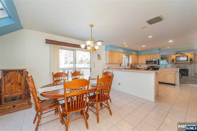 342 Mount Pleasant Ave, Rockaway Township, NJ 07801 - tiled dining space featuring an inviting chandelier and a large fireplace