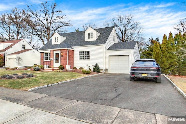 cape cod home featuring a front yard and a garage