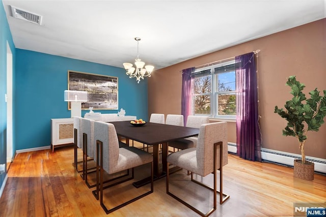 dining room featuring a chandelier and light hardwood / wood-style flooring