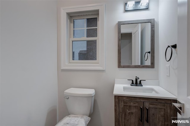 bathroom featuring toilet and vanity