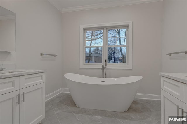 bathroom featuring ornamental molding, a bathing tub, and vanity