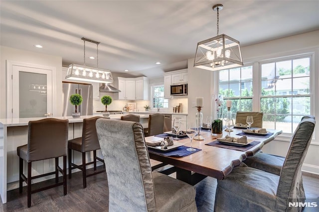 dining room featuring dark wood-type flooring, a wealth of natural light, and sink