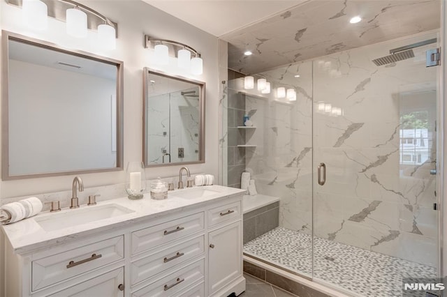 bathroom with tile patterned floors, walk in shower, and vanity