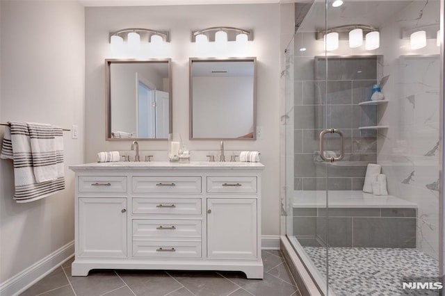 bathroom with vanity, an enclosed shower, and tile patterned flooring