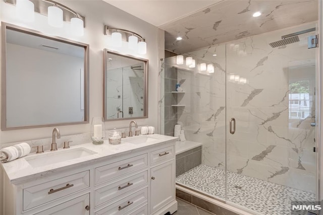 bathroom with a shower with door, tile patterned flooring, and vanity