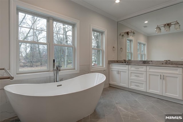 bathroom featuring ornamental molding, a bath, tile walls, and vanity