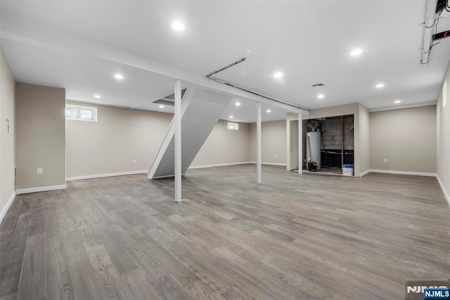 basement with light hardwood / wood-style flooring