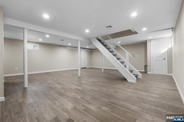 basement with light hardwood / wood-style flooring