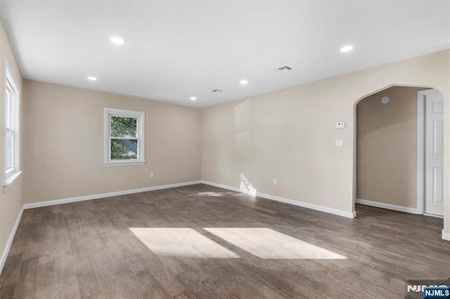 spare room with dark wood-type flooring