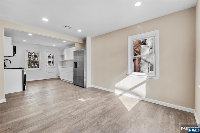 unfurnished living room featuring light hardwood / wood-style floors