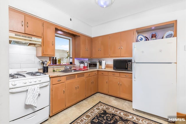 kitchen with sink, white appliances, and decorative backsplash