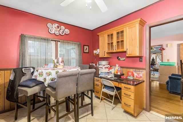 tiled dining area featuring ceiling fan