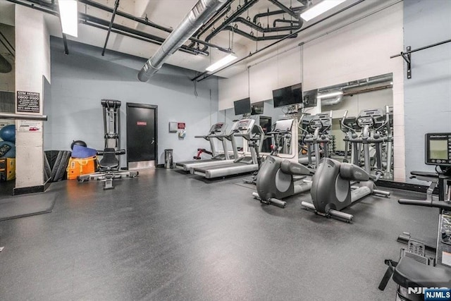 workout area with a towering ceiling