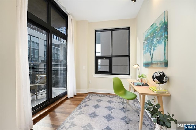 office space with wood finished floors and baseboards