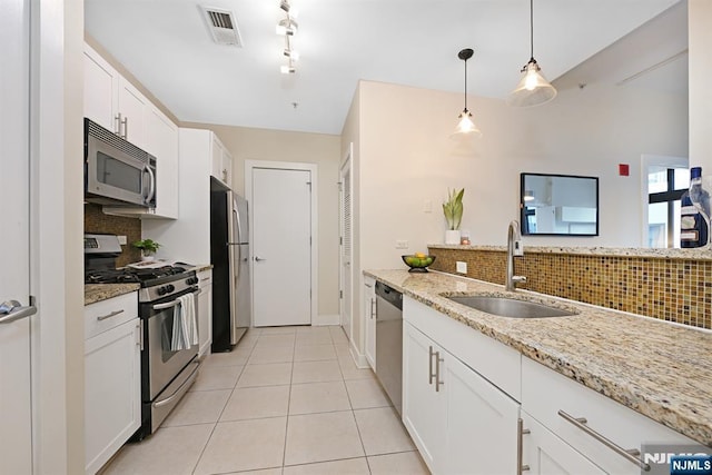 kitchen with visible vents, a sink, white cabinetry, appliances with stainless steel finishes, and light tile patterned flooring