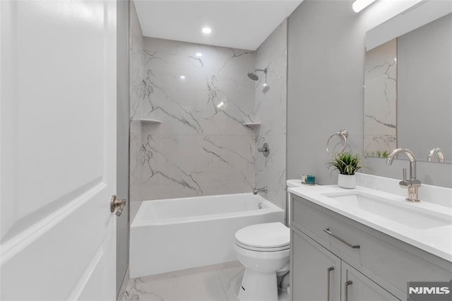 full bathroom with vanity, toilet, and tiled shower / bath combo