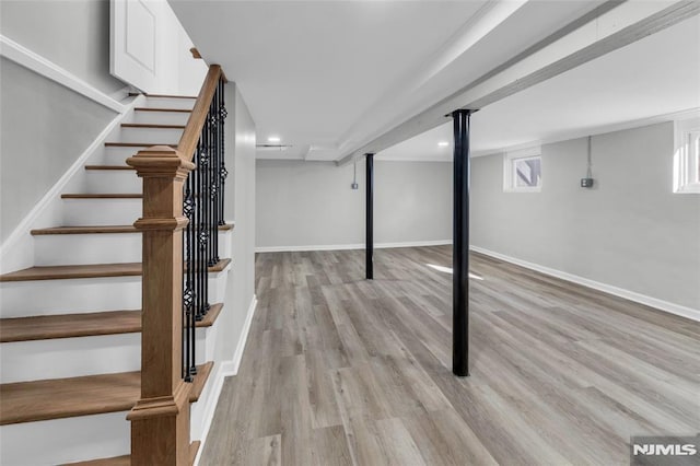 basement with light hardwood / wood-style floors