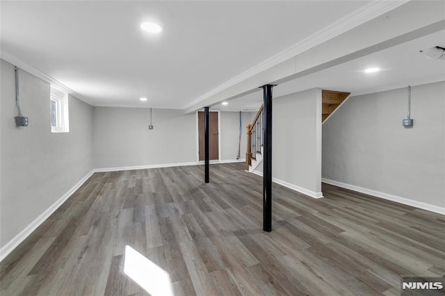 basement featuring ornamental molding and hardwood / wood-style floors