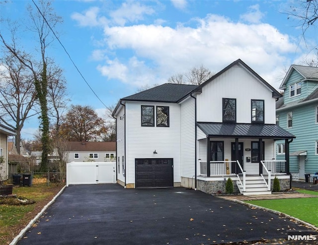 view of front of house featuring a garage and covered porch