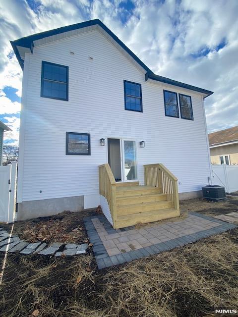 rear view of house with cooling unit