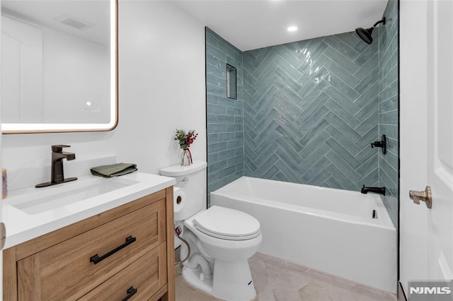 full bathroom featuring tiled shower / bath combo, vanity, tile patterned floors, and toilet