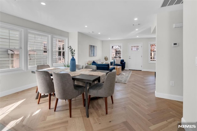 dining area featuring light parquet flooring