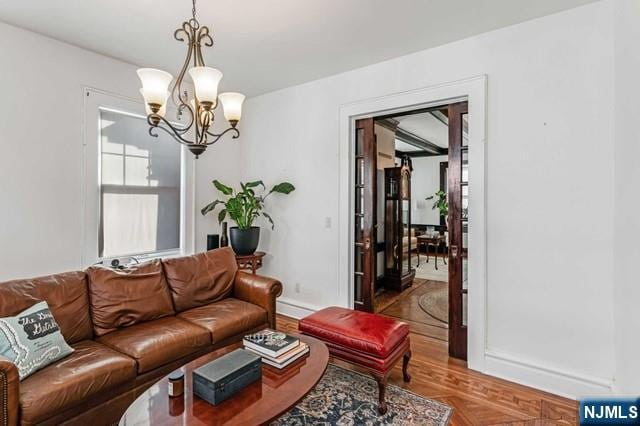 living room with a chandelier and hardwood / wood-style floors