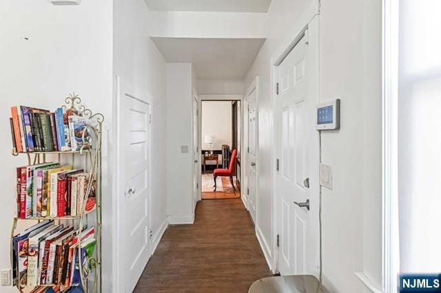 hallway with dark hardwood / wood-style floors