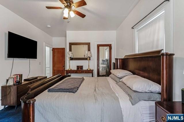 carpeted bedroom featuring ceiling fan