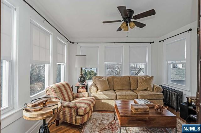 sunroom with radiator and ceiling fan