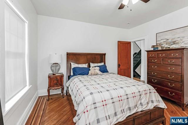 bedroom featuring ceiling fan and dark hardwood / wood-style floors