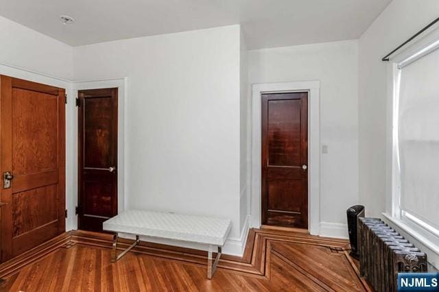 interior space featuring hardwood / wood-style floors and radiator heating unit