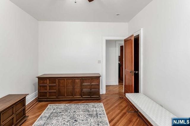 living area with ceiling fan and light wood-type flooring