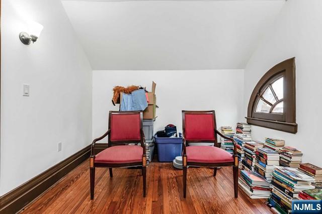 sitting room with lofted ceiling and hardwood / wood-style floors