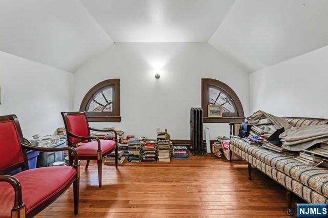 interior space with lofted ceiling and hardwood / wood-style floors