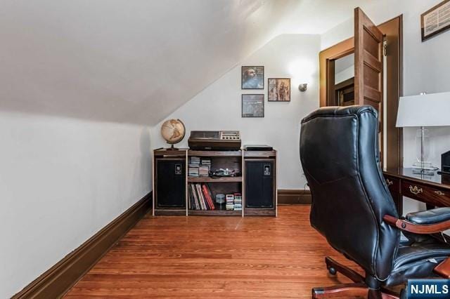 home office featuring vaulted ceiling and hardwood / wood-style floors