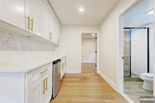 interior space featuring white cabinetry, light hardwood / wood-style flooring, and tasteful backsplash