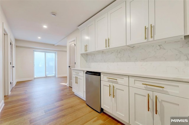 kitchen featuring backsplash, light hardwood / wood-style flooring, dishwasher, and white cabinets