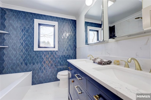 bathroom with vanity, toilet, tile walls, and crown molding